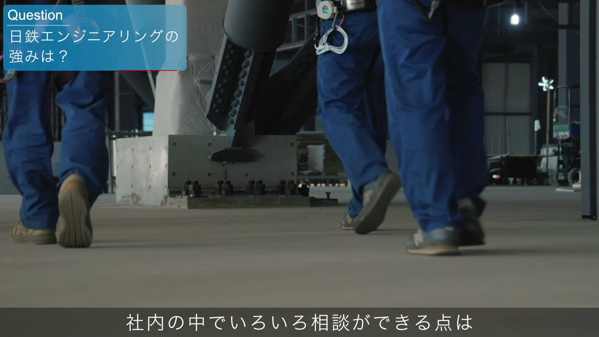 現場の床を歩く作業着の足元